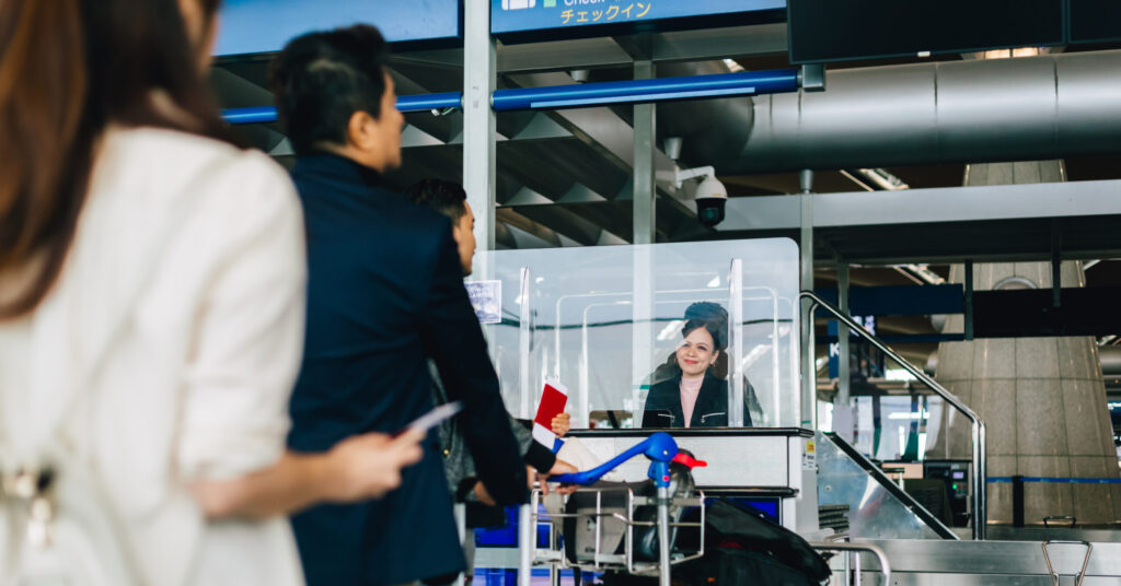 Three airport passengers lining up to show ID.