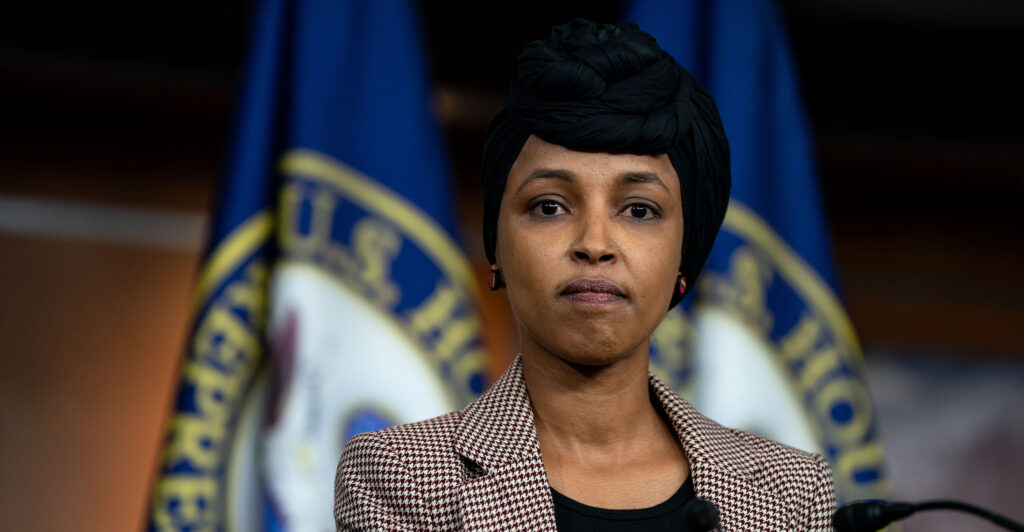 Ilhan Omar wear stands wearing a black hajib.