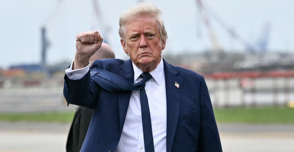 President Donald Trump gestures, shaking a fist.