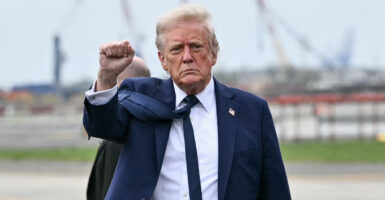 President Donald Trump gestures, shaking a fist.
