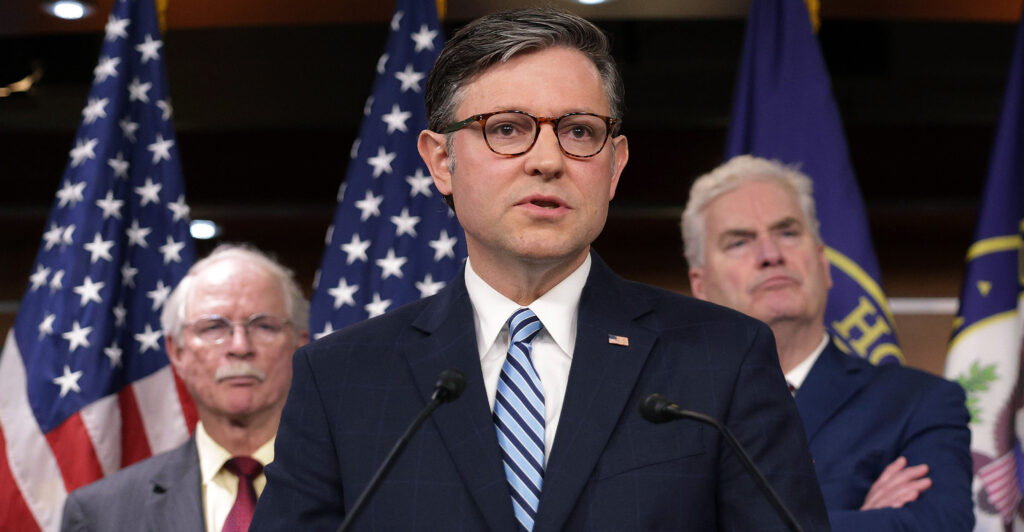 Speaker of the House Rep. Mike Johnson, R-La., speaks as Rep. John Rutherford, R-Fla. (left), and House Majority Whip Rep. Tom Emmer, R-Minn., look on at a news conference at the Capitol on Wednesday.