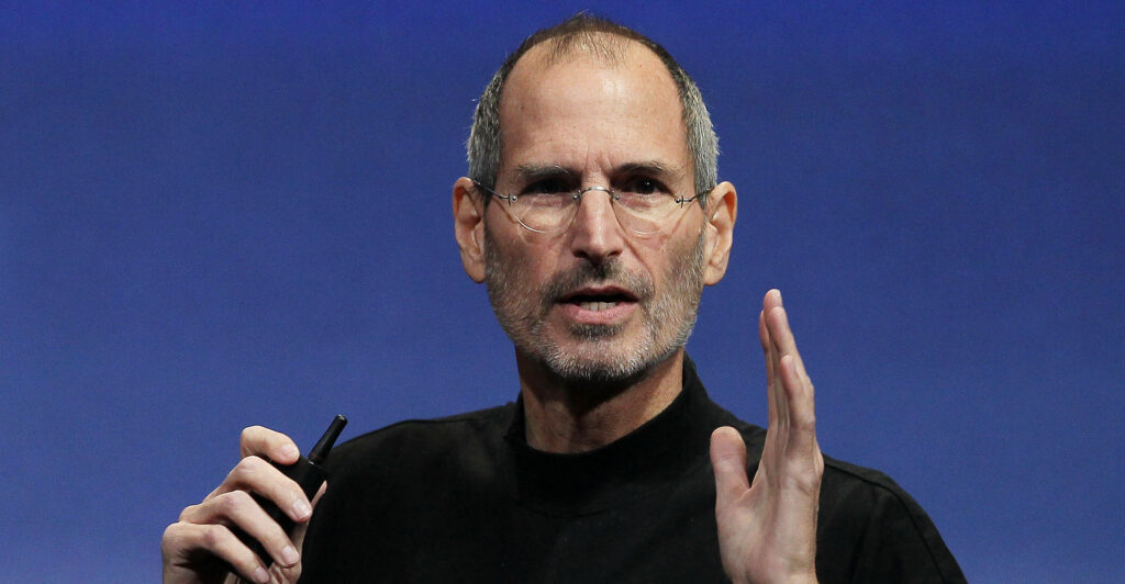 Steve Jobs wearing a black shirt while gesturing.