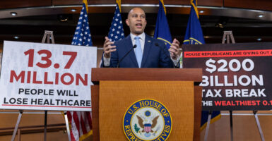House Minority Leader Hakeem Jeffries, D-N.Y. (center), talks to the media on Tuesday.
