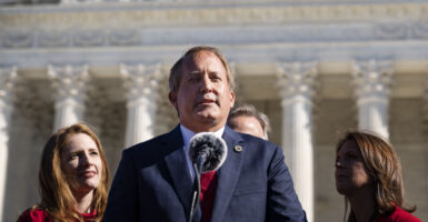 Texas Attorney General Ken Paxton speaks in front of the U.S. Supreme Court building.