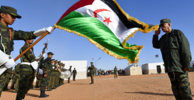 Polisario Secretary General salutes the Sahrawi flag.