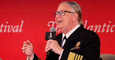 Rachel Levine laughs while holding a microphone