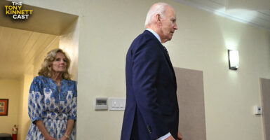 Joe Biden walks away as wife Jill Biden looks on.