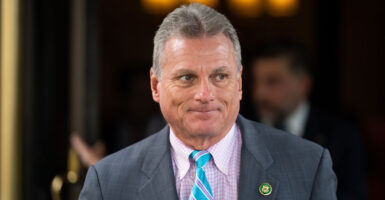 Rep. Buddy Carter, R-Ga. in grey suit with light purple shirt and bright light blue tie.