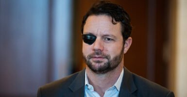 Rep. Dan Crenshaw, R-Texas, leaves a meeting of the House Republican Conference at the Cannon House Office Building on Jan. 7.