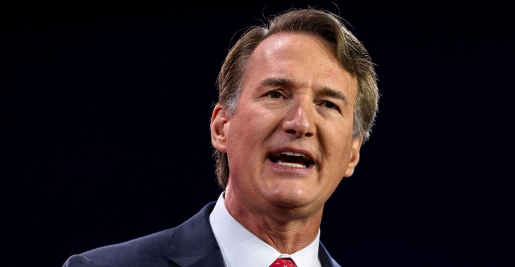 close-up of Virginia Gov. Glenn Youngkin in a blue suit and red tie on stage