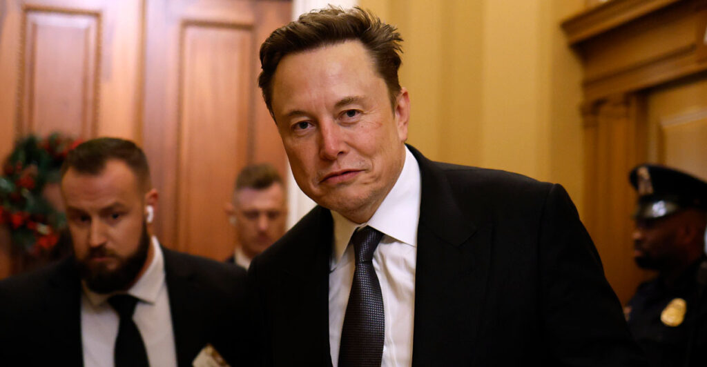 DOGE head Elon Musk in a black suit and tie walking through the halls of Congress