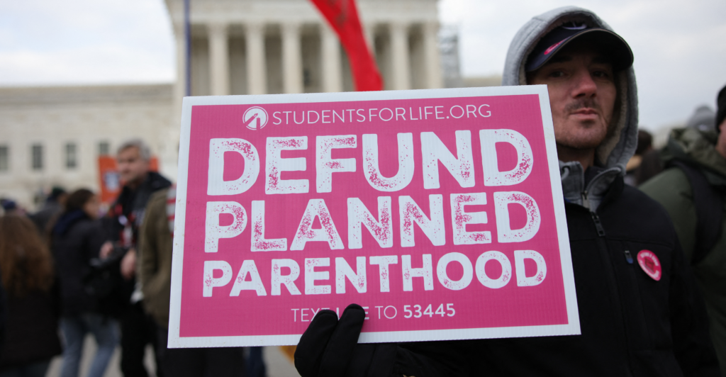 Pro-life activists demonstrate outside the Supreme Court during the 52nd annual March For Life on Jan. 24, calling for Planned Parenthood's federal funding to be eliminated.