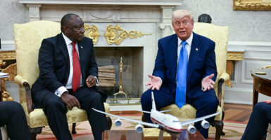 President Donald Trump confers with South African President Cyril Ramaphosa in the Oval Office on Wednesday.
