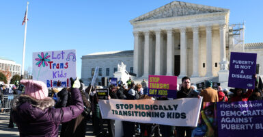 Protesters clash Dec. 4 outside the Supreme Court over the issue of transitioning children on the morning the justices heard oral arguments in U.S. v. Skrmetti.