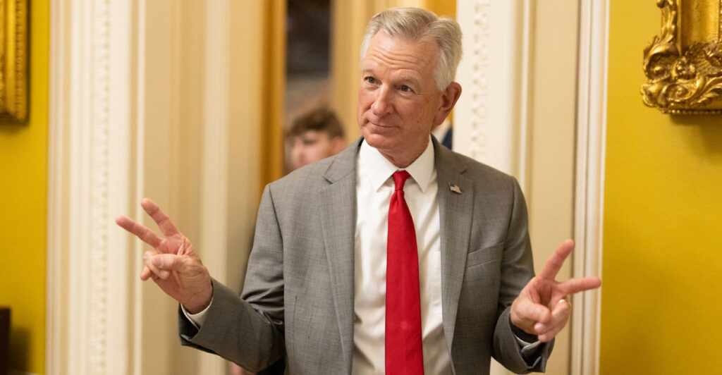 Sen. Tommy Tuberville, R-Ala., wearing a white shirt with a red tie.