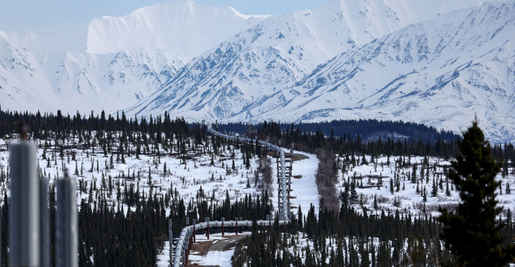 A part of the Trans Alaska Pipeline System runs through boreal forest past Alaska Range mountains on May 5, 2023, near Delta Junction, Alaska.