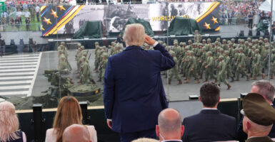 President Donald Trump salutes troops during the celebration of the Army's 250th birthday on Saturday in Washington, D.C.