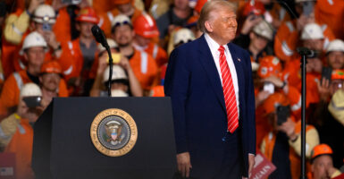 President Donald Trump speaks to steelworker supporters wearing hard hats and orange vests on May 30 in West Mifflin, Pennsylvania.