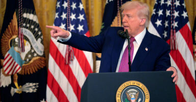 President Donald Trump at a lectern with a U.S. flag as backdrop