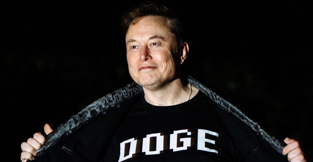 Elon Musk walks to the White House wearing a DOGE shirt.