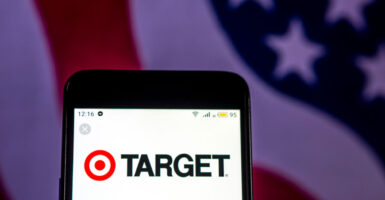 A cellphone displays the Target department store chain's logo against the backdrop of an American flag.