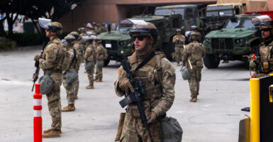 National Guard troops stand outside the Metropolitan Detention Center in Los Angeles on Sunday.