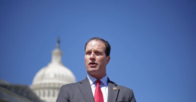Rep. August Pfluger, R-Texas, speaks in front of the U.S. Capitol against a perfect blue sky.
