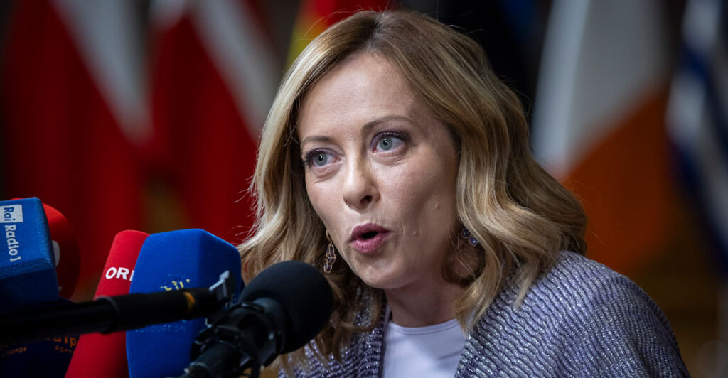 Close-up of Italian Prime Minister Georgia Meloni speaking into a microphone.