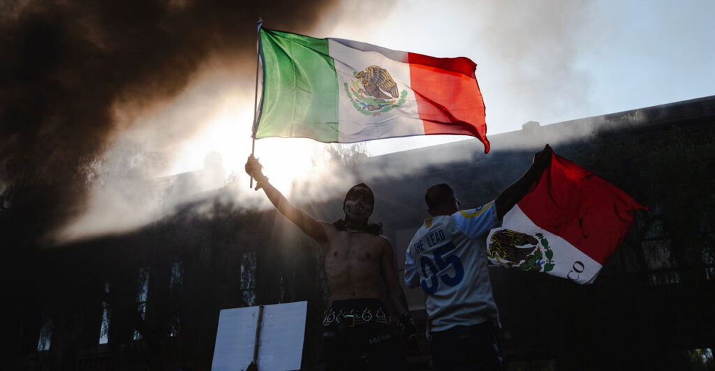 LA Riot. As smoke rises behind them protesters wave Mexican flags.