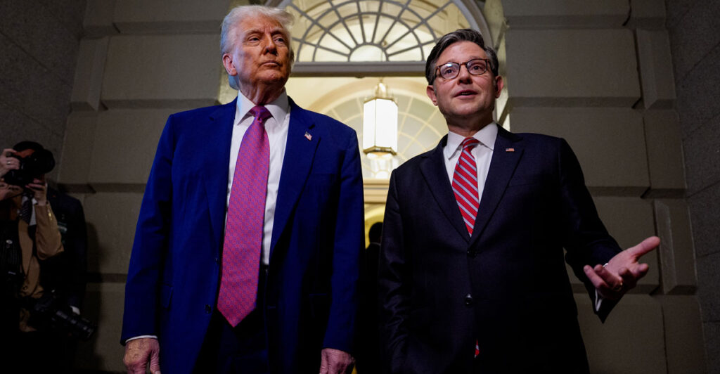 President Donald Trump and House Speaker Mike Johnson stand together inside the U.S. Capitol.