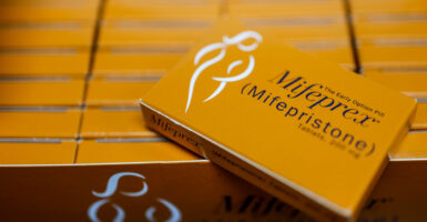 Numerous orange boxes of Mifepristone.