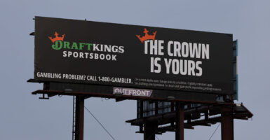 A DraftKings sportsbook billboard with slogan "The Crown is Yours."
