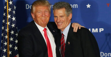 President Donald Trump embraces former Sen. Scott Brown, who is seeking a return to the Senate.