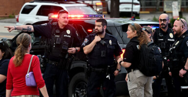Police officers at the scene of the Boulder arson attack