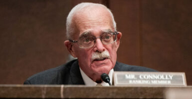 Rep. Gerry Connolly in a suit speaking at a congressional committee hearing