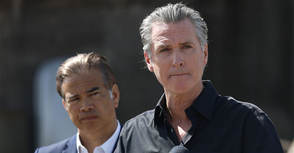 California Gov. Gavin Newsom purses his lips as state AG Rob Bonta looks on.