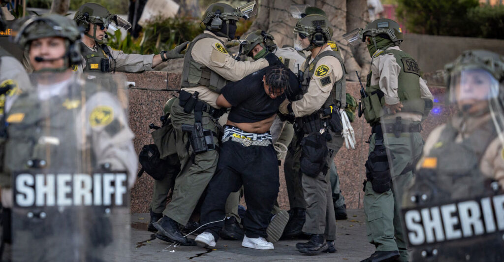 a demonstrator surrounded and arrested by LA Sheriff's deputies