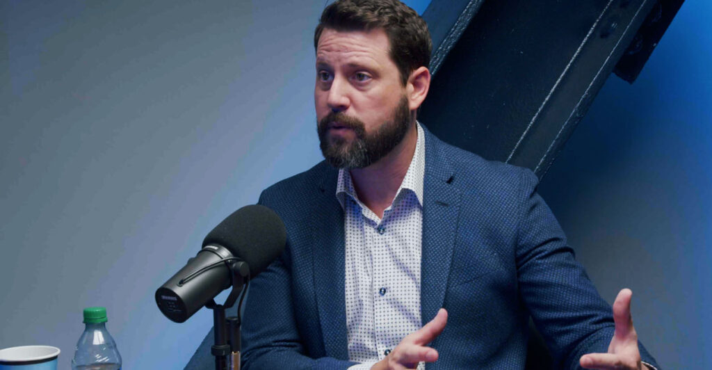 Babylon Bee CEO Seth Dillon speaking into microphone