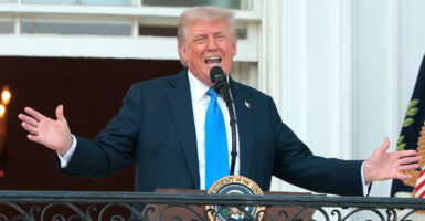 President Donald Trump, wearing a powder-blue tie, speaks to guests from the South Portico of the White House during an event on the South Lawn on Wednesday.