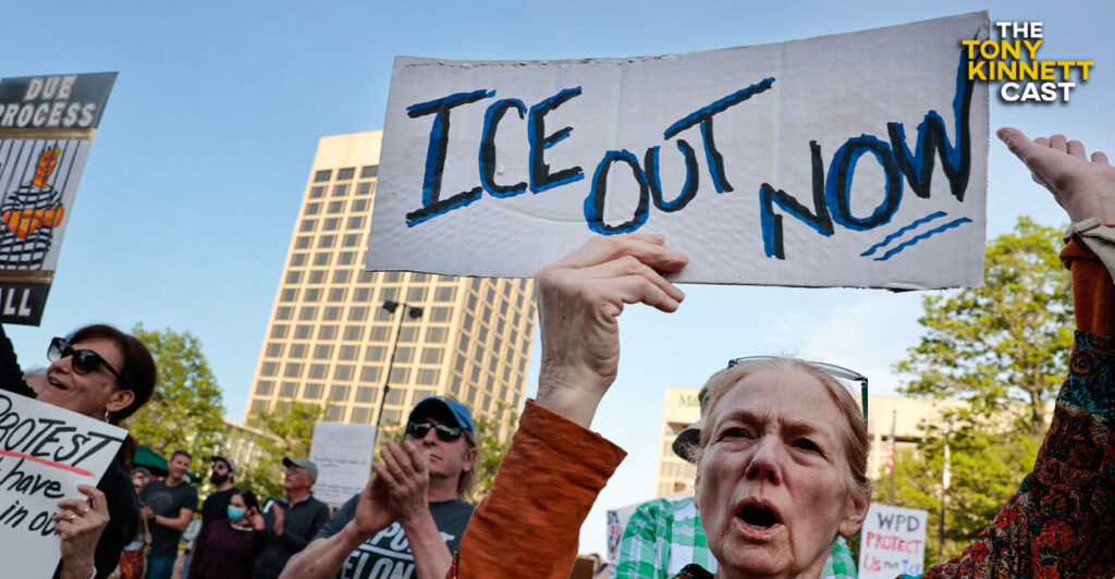 A pro-illegal immigration activist sports a homemade "ICE out now" sign.