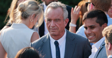 HHS Secretary Robert F. Kennedy in a crowd on White House lawn.