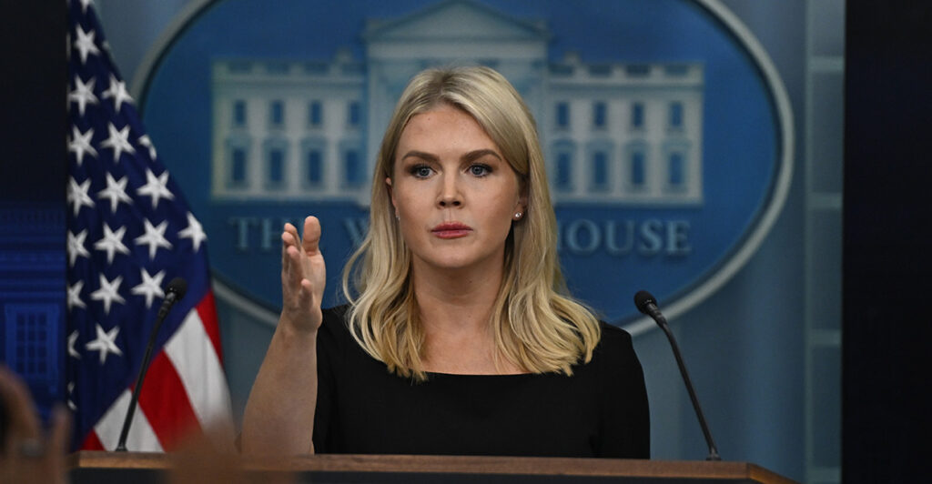 Press secretary Karoline Leavitt signals with her right hand during White House press briefing.