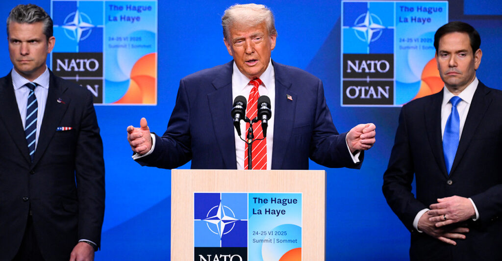 President Trump, flanked by Pete Hegseth and Marco Rubio gestures while speaking to reporters at the NATO summit.