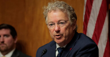 Sen. Rand Paul in a dark suit speaking at a committee hearing
