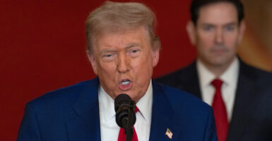 Close-up of President Donald Trump explaining his decision to attack Iran nuclear sites. Secretary of State Marco Rubio stands behind him.