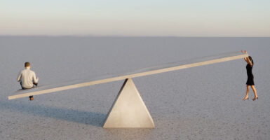 An artist's rendering of a man and a woman on opposite ends of a seesaw