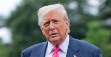 Donald Trump looks straight ahead during a press conference.