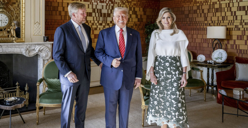President Donald Trump gives a thumbs up, while flanked by King Willem-Alexander of the Netherlands and Queen Maxima at Paleis Huis ten Bosch in The Hague.
