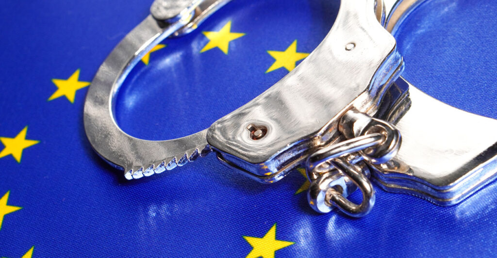 A pair of handcuffs on the blue, with a circle of gold stars, flag of the European Union.