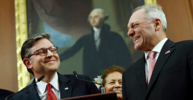 A beaming Mike Johnson and Steve Scalice celebrate passage of the One Big Beautiful Bill Act in front of a portrait of George Washington.